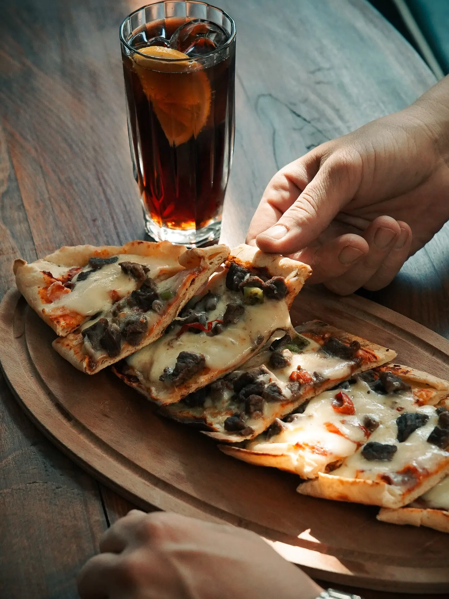 Freshly baked Turkish beef pide served on a wooden board at Chimney Bistro